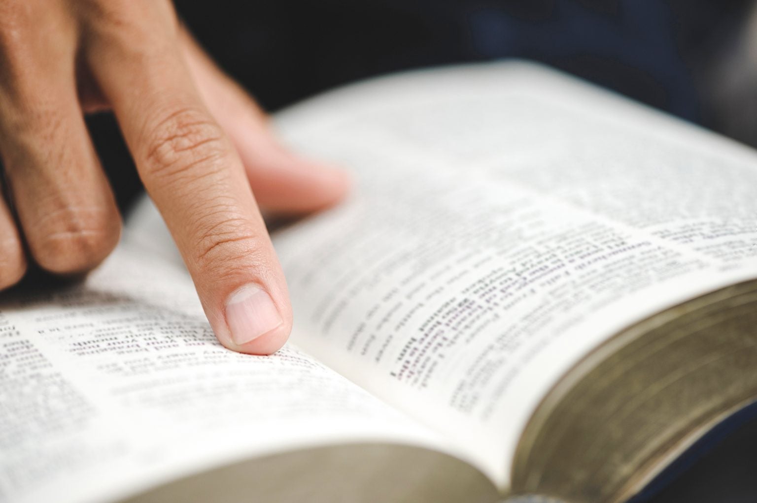 Close-up of man's hands while studying the Bible. License # 441959239.