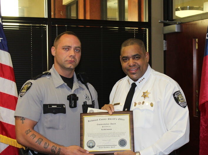 Deputy Keith Inman, left, was commended by Richmond County Sheriff Richard Roundtree in 2017 after Inman and another officer gave CPR and revived an unresponsive man. Friday, a Richmond County jury found a man who seriously injured Inman, Kaylon Smith, not guilty of aggravated assault.