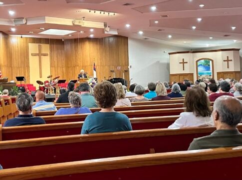 Some 174 University Hospital-Piedmont retirees meet with attorney Jack Long to discuss a lawsuit against the hospital to block it from stopping a promised lifetime benefit.