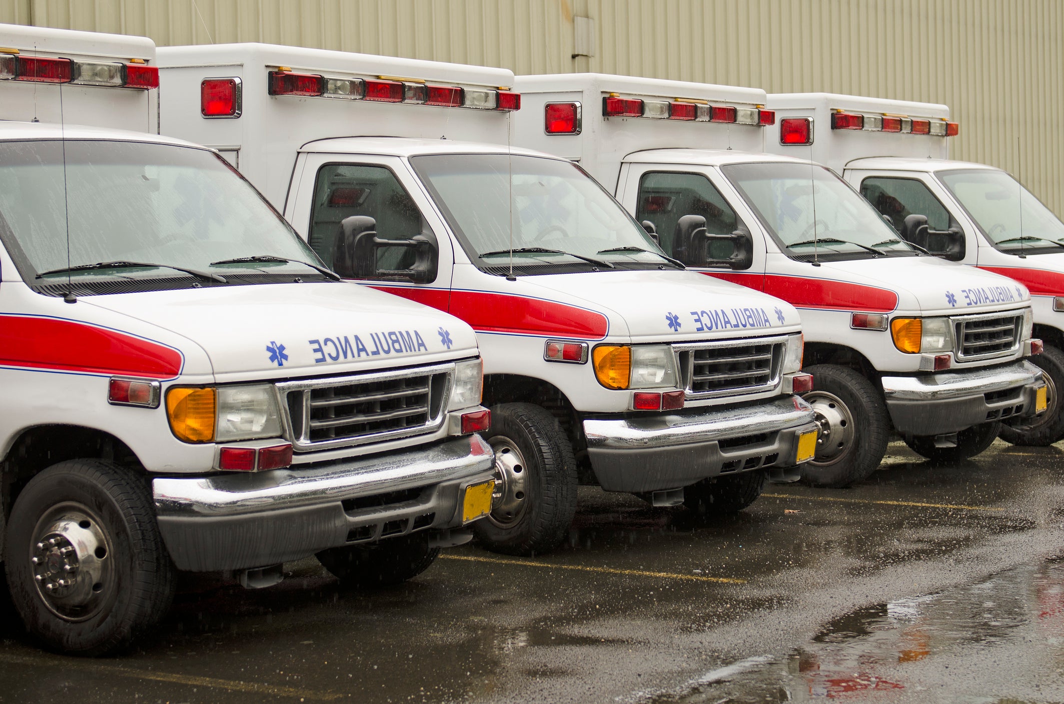 A fleet of ambulances is parked outside a hospital. Augusta is one of a handful of places in Georgia where ambulance service is controlled by a private provider.