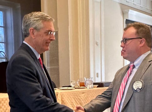 Georgia Secretary of State Brad Raffensperger, left, shakes hands with attorney Charles Rollins after speaking to the Kiwanis Club of Augusta Monday at St. Paul's Church.