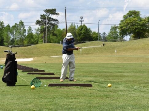 A man practices at the driving range at First Tee of Augusta. Staff photo by Liz Wright