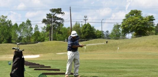 A man practices at the driving range at First Tee of Augusta. Staff photo by Liz Wright