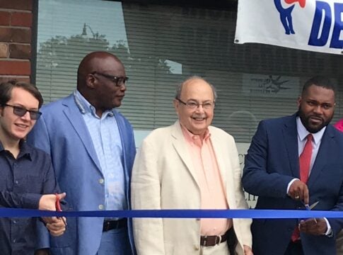 Lowell Greenbaum, center, at the 2019 ribbon cutting for the Richmond County Democratic Party headquarters. Greenbaum, a party heavyweight, died Tuesday at age 94. Staff photo by Susan McCord