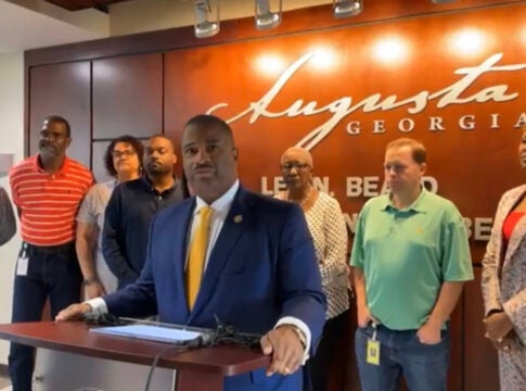 Augusta Mayor Garnett Johnson, center, makes a statement about the network outage Tuesday. Staff photo by Susan McCord