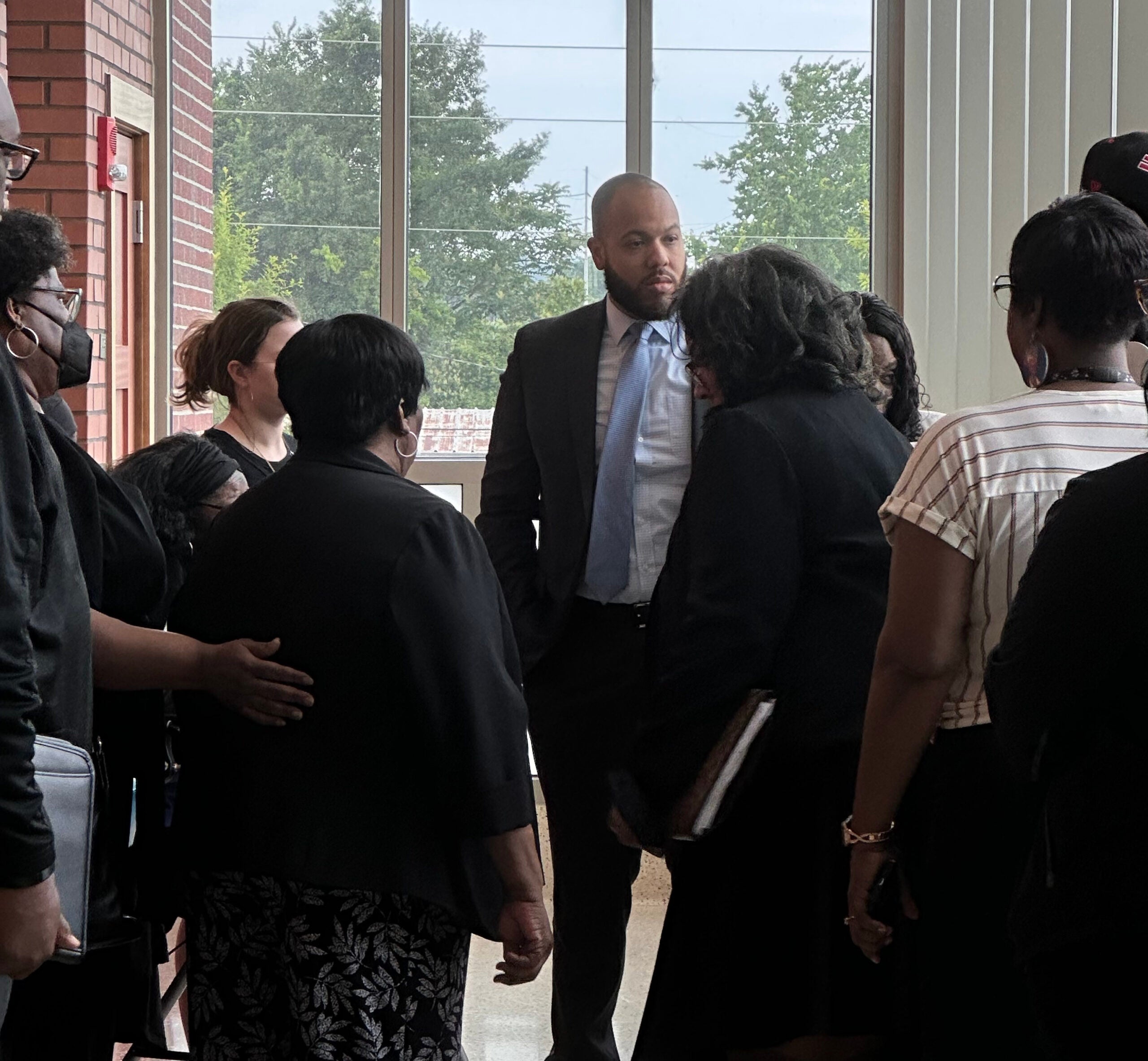 Augusta Circuit District Attorney Jared Williams, center, speaks with family members of Elizabeth Thompson Monday. Staff photo by Susan McCord
