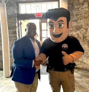 Mayor Garnett Johnson greets a larger-than-life Richmond County Sheriff's deputy at Augusta on Display, a trade-show-style event that showcases city departments. Photo courtesy Augusta mayor's office