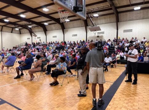 Business owners and neighborhood residents filled the bleachers at Warren Road gym to learn about a new program to help businesses fight crime tied to homelessness. Staff photo by Susan McCord