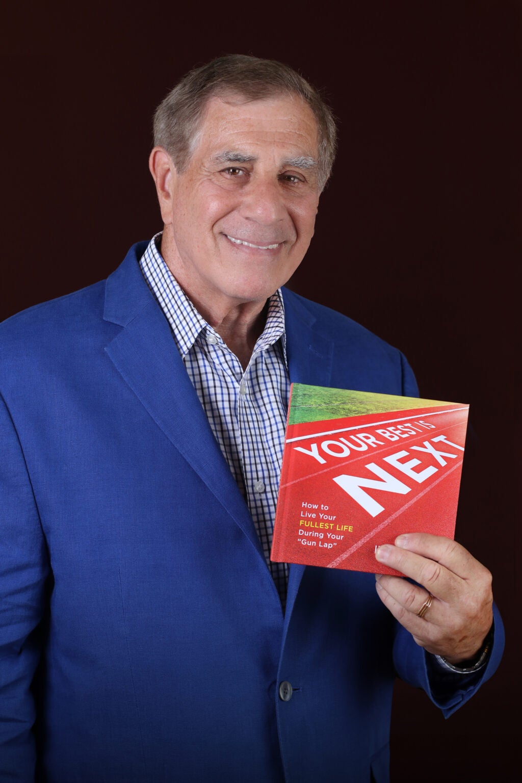 Picture of Ira holding his book about leadership