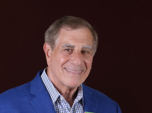 Picture of Ira holding his book about leadership