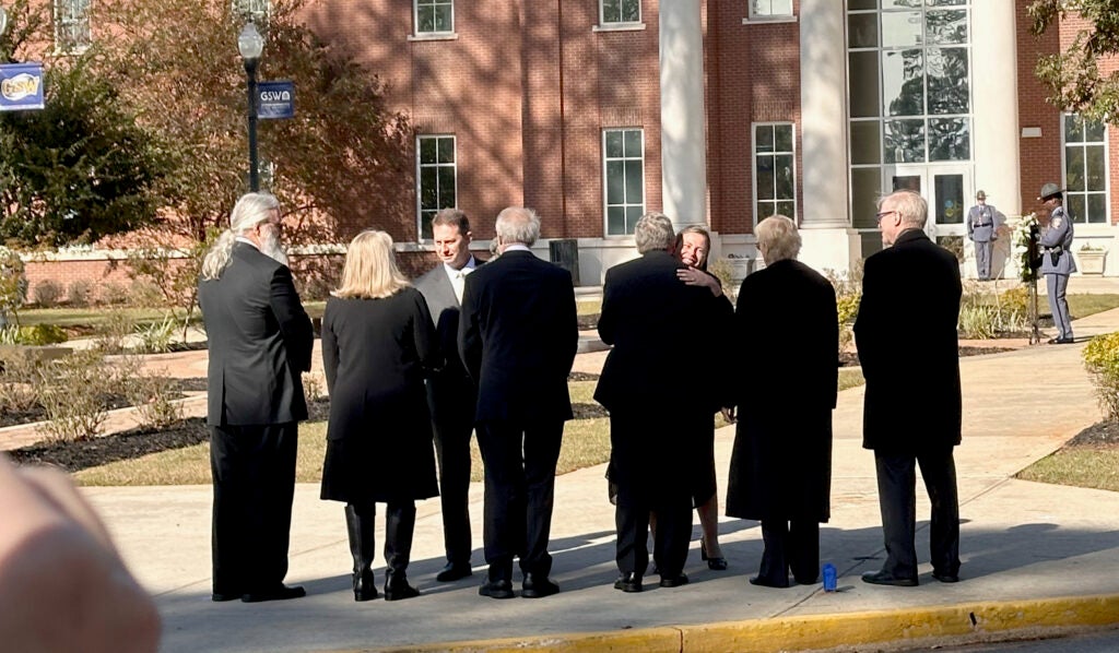 Georgia Southwestern State University President Neal Weaver and Rosalynn Carter Institute for Caregiving President Jennifer Olsen greet the four children of Jimmy and Rosalynn Carter at a wreath-laying ceremony Nov. 27, 2023. Staff photo by Susan McCord