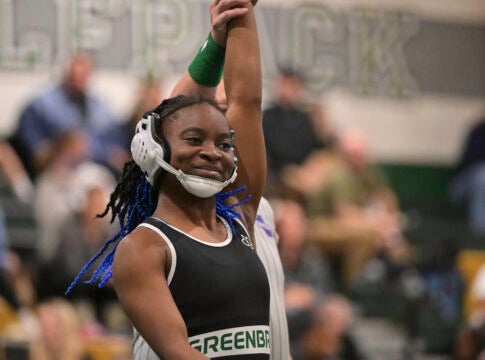 Greenbrier's Jade Stephens has her hand raised in victory after defeating Dayva Badger of Burke County by first period fall at 125 pounds during Friday's area duals tournament at Greenbrier Middle School. The Lady Wolfpack won their second straight area duals meet, and will compete in the second GHSA girls state duals wrestling tournament at West Georgia in Carrollton January 26. Staff photo by Rob Davis.