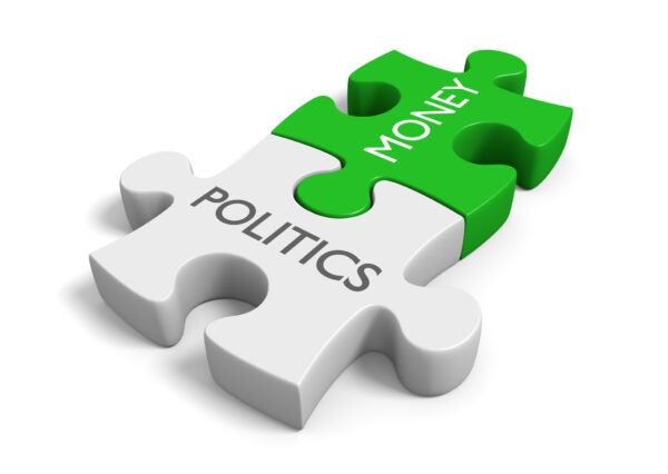 Politics and money puzzle representing corruption of wealth in elections