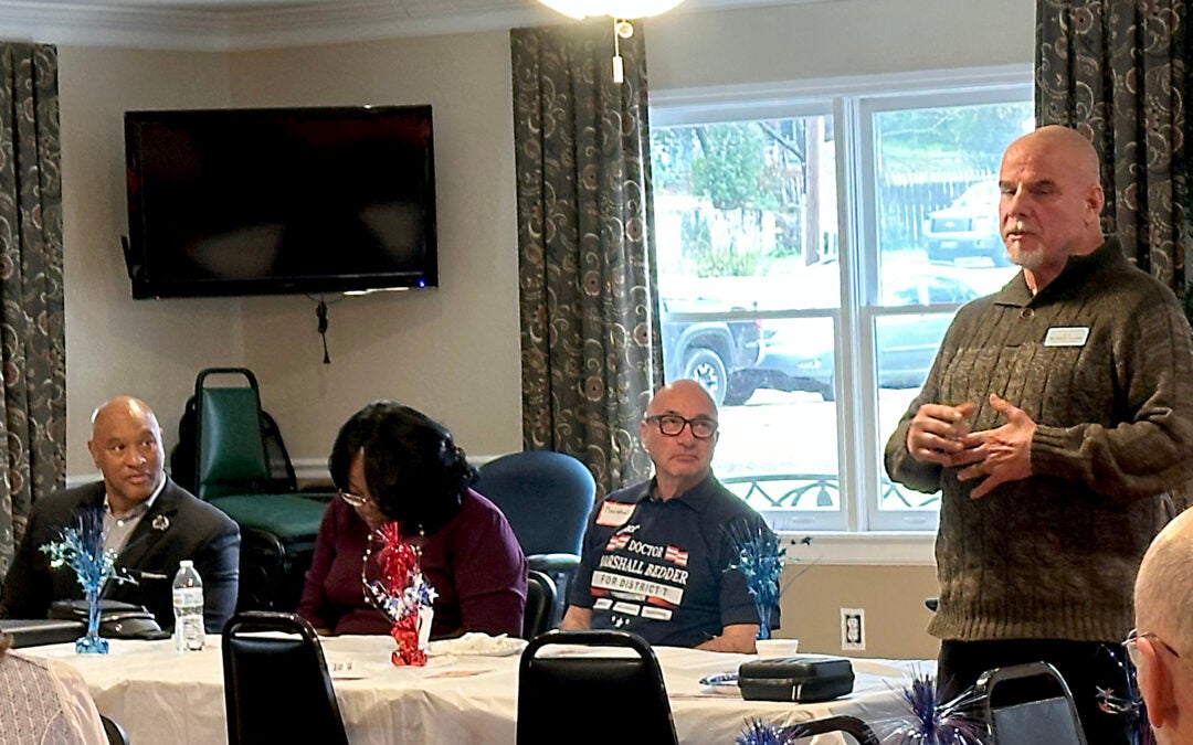 Richmond County Sheriff candidate Eugene Brantley, left, and Augusta Commission candidate Marshall Bedder, center, eye sheriff's candidate Richard Dixon, right, as he speaks to a March 9 gathering of Augusta Republicans. Staff photo by Susan McCord