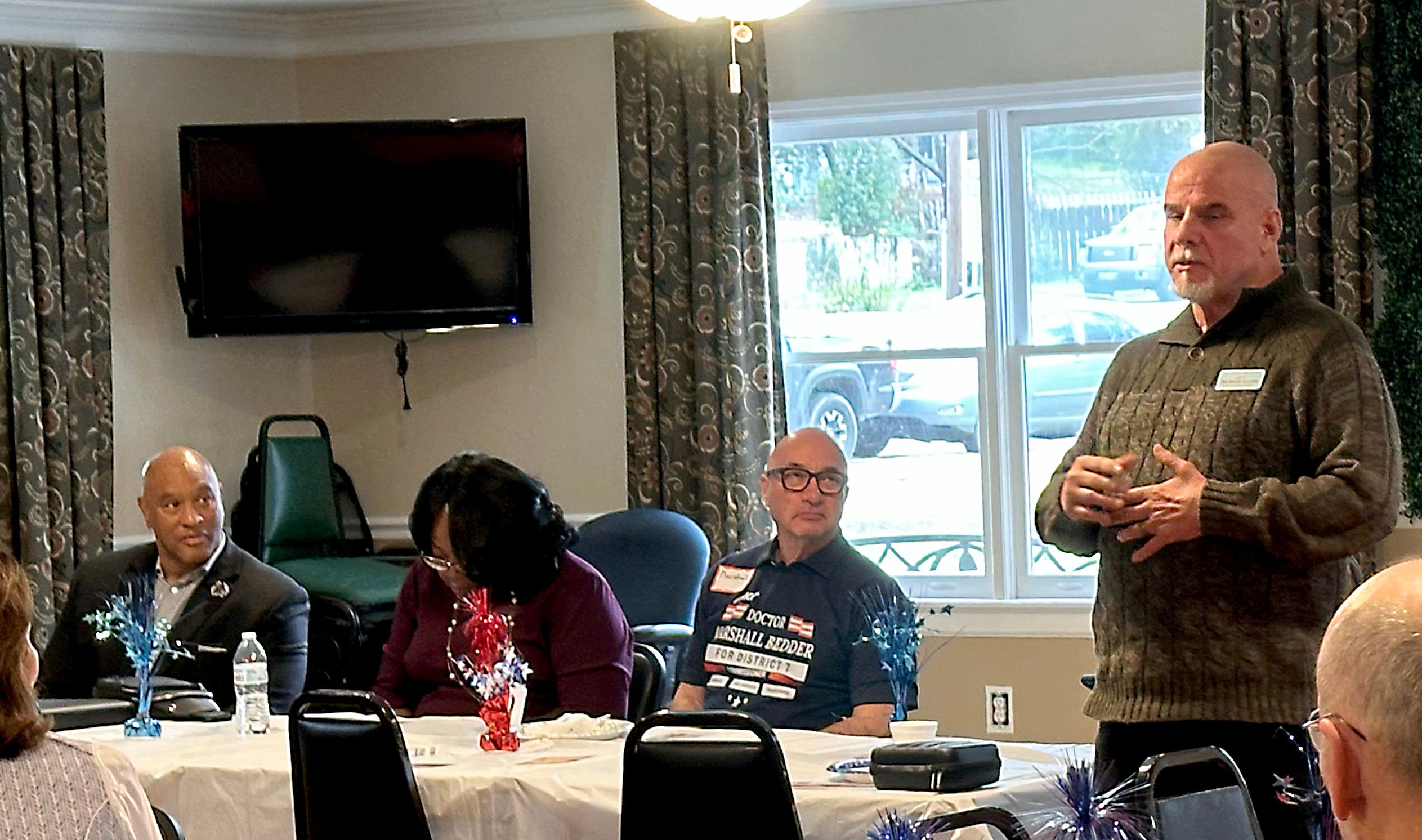 Richmond County Sheriff candidate Eugene Brantley, left, and Augusta Commission candidate Marshall Bedder, center, eye sheriff's candidate Richard Dixon, right, as he speaks to a March 9 gathering of Augusta Republicans. Staff photo by Susan McCord