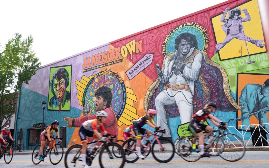 Men Junior 13-14 year old cyclist racing past the James Brown mural in Downtown Augusta.