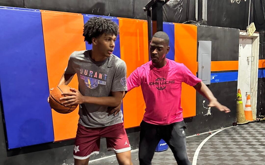 Augusta basketball trainer Darrin Shine, right, works with Washington D.C. top-100 point guard prospect Acaden Lewis during Peach Jam week. Shine has been opening his facility to Peach Jam players from across the country since 2018, and hopes to do more in the future. | Staff photo by Gabriel Stovall.