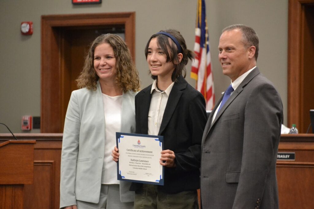 Kathryn Lawrence, an 8th grader at Columbia Middle School, received 8th place in visual arts, recyclable art at the National Beta Convention. Pictured is Lawrence with CMS Principal Dr. Holly Barnes and Superintendent Dr. Steven Flynt. Staff photo by Stephanie Hill