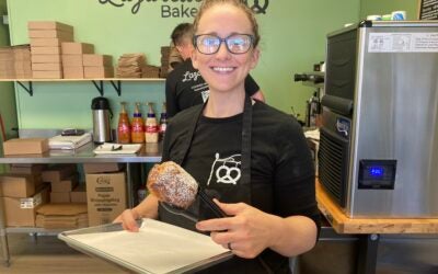 Kyrie Juchemich holds up a chocolate croissant, one of the many items sold at the bakery. Staff photo by Stephanie Hill