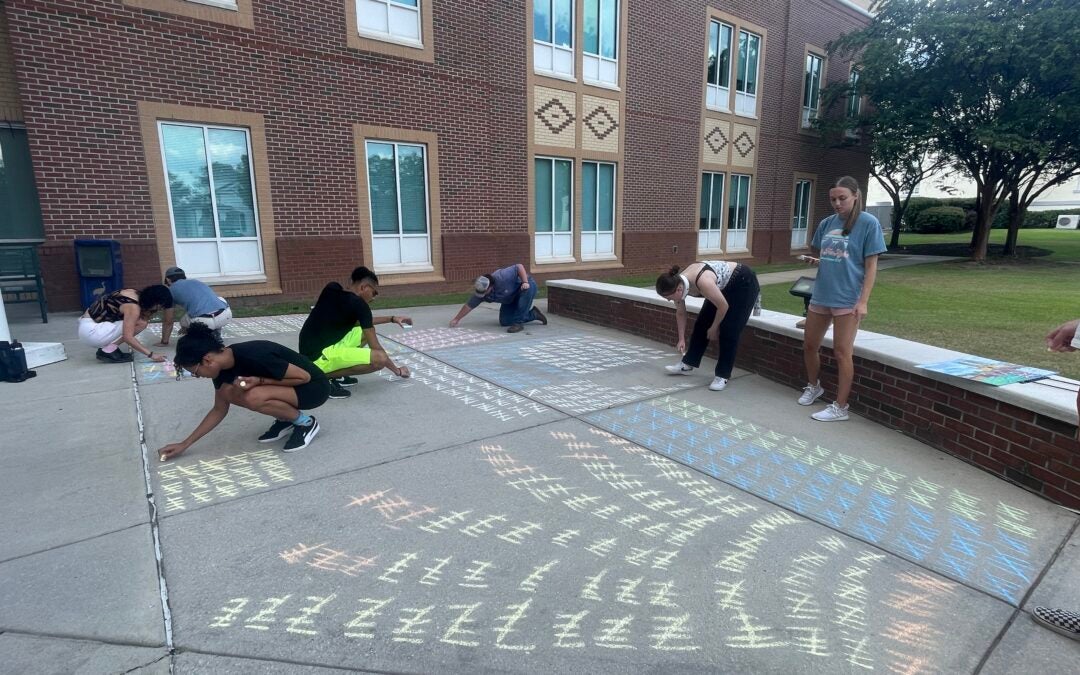 Augusta University sociology students undertook a project to show how many homicides there were in the U.S. in 2022. Staff photo by Skyler Q. Andrews