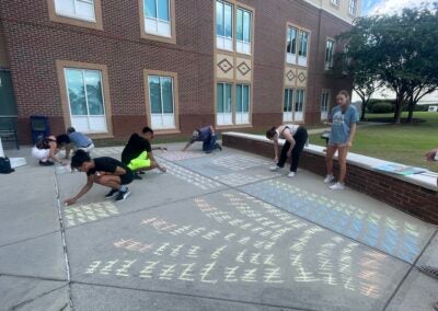 Augusta University sociology students undertook a project to show how many homicides there were in the U.S. in 2022. Staff photo by Skyler Q. Andrews
