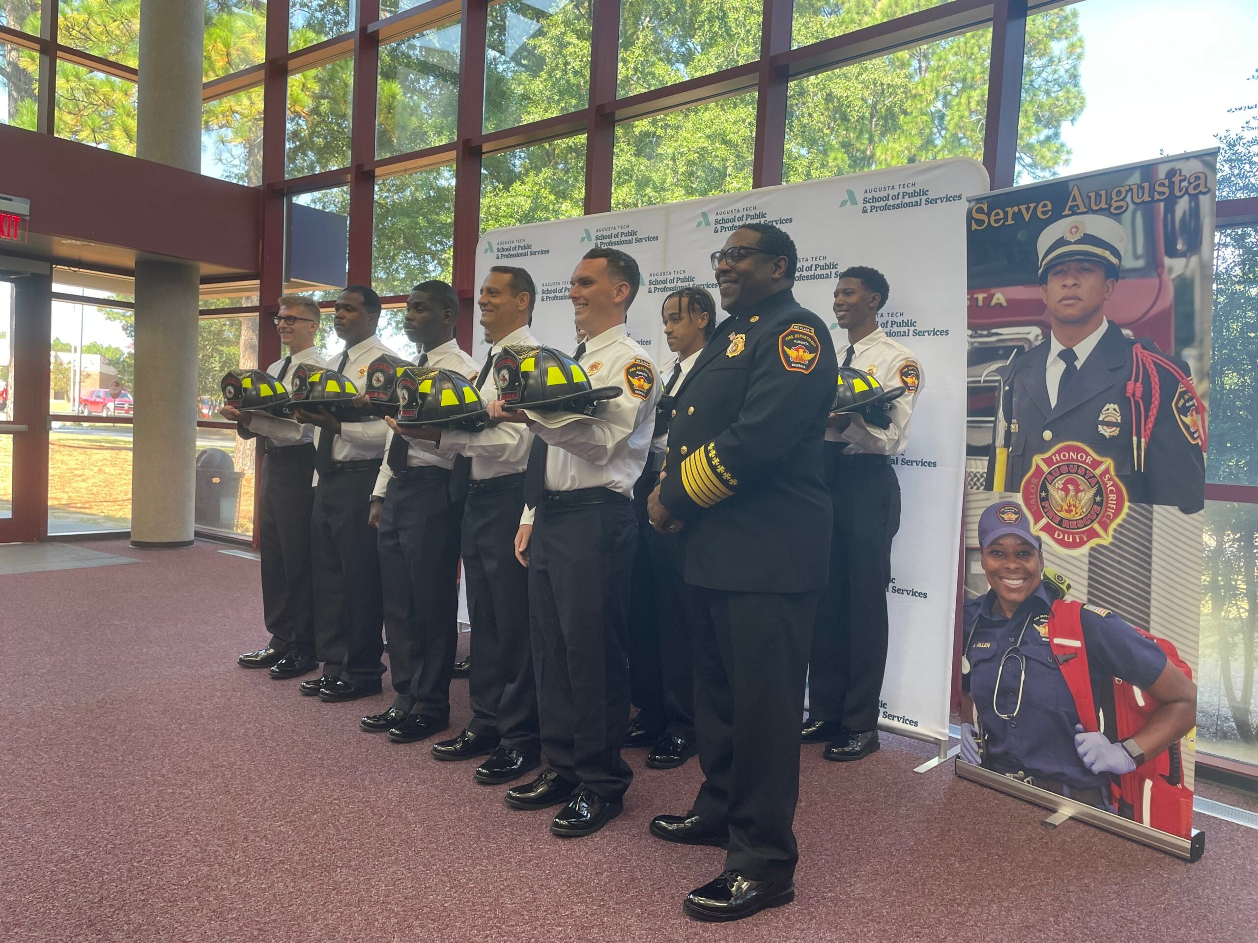Fire Chief Antonio Burden poses for photos with the 13 new firefighters, of the graduating Recruit Class of 24-03. Photo by Skyler Andrews.