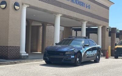 cop cruiser parking in front of Richmond County school