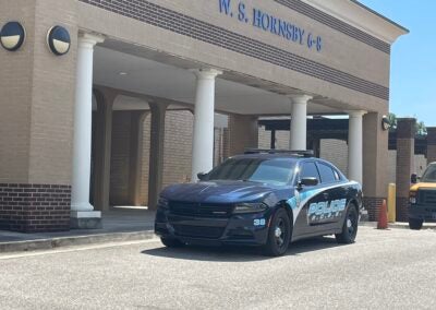 cop cruiser parking in front of Richmond County school