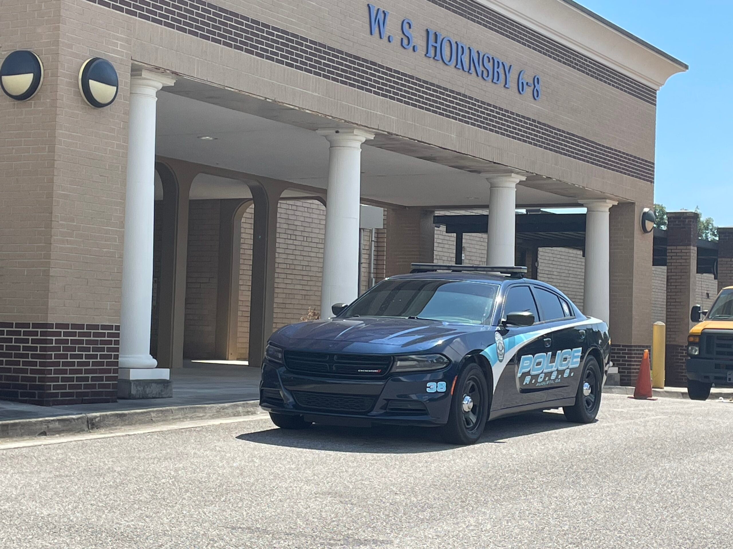 cop cruiser parking in front of Richmond County school