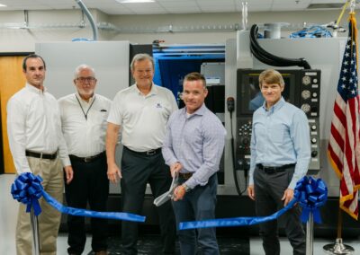 Jason Burkhardt, NNSA Director for SRS Plutonium Modernization, cuts the ribbon to officially open the Machining Training Center at SRS. Also pictured from left to right: Patrick Schneider, Pit Production Operations – Area Operations Director; Rick Nash, MTC Operations; Dennis Carr, SRNS President and CEO; and Dr. Marvin Adams, NNSA Deputy Administrator for Defense Programs.