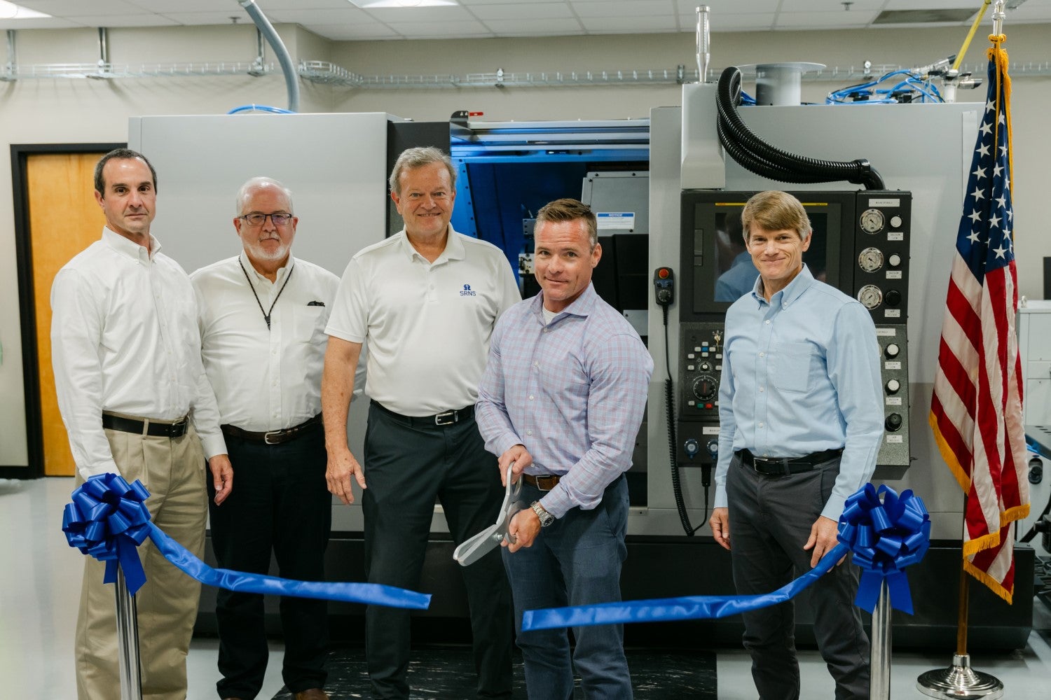 Jason Burkhardt, NNSA Director for SRS Plutonium Modernization, cuts the ribbon to officially open the Machining Training Center at SRS. Also pictured from left to right: Patrick Schneider, Pit Production Operations – Area Operations Director; Rick Nash, MTC Operations; Dennis Carr, SRNS President and CEO; and Dr. Marvin Adams, NNSA Deputy Administrator for Defense Programs.
