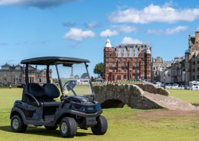 A new Club Car Tempo golf car next to the Swilcan Bridge on the Old Course, St Andrews.