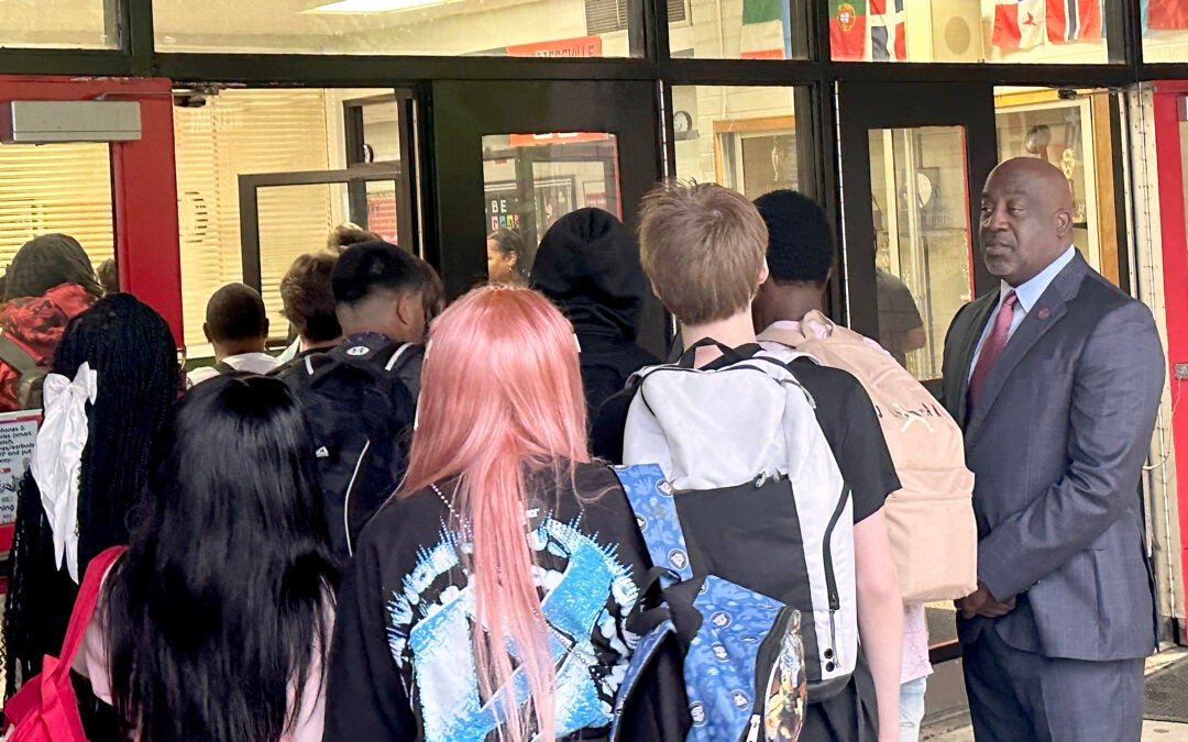 Superintendent Kenneth Bradshaw, right, welcomes students on the first day of school Tuesday at Hephzibah High School. Susan McCord/Staff