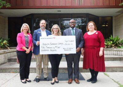 Photo of Augusta Tech holding check