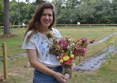 Annie Goble shows off a bouquet of flowers from her flower farm. Staff photo by Stephanie Hill