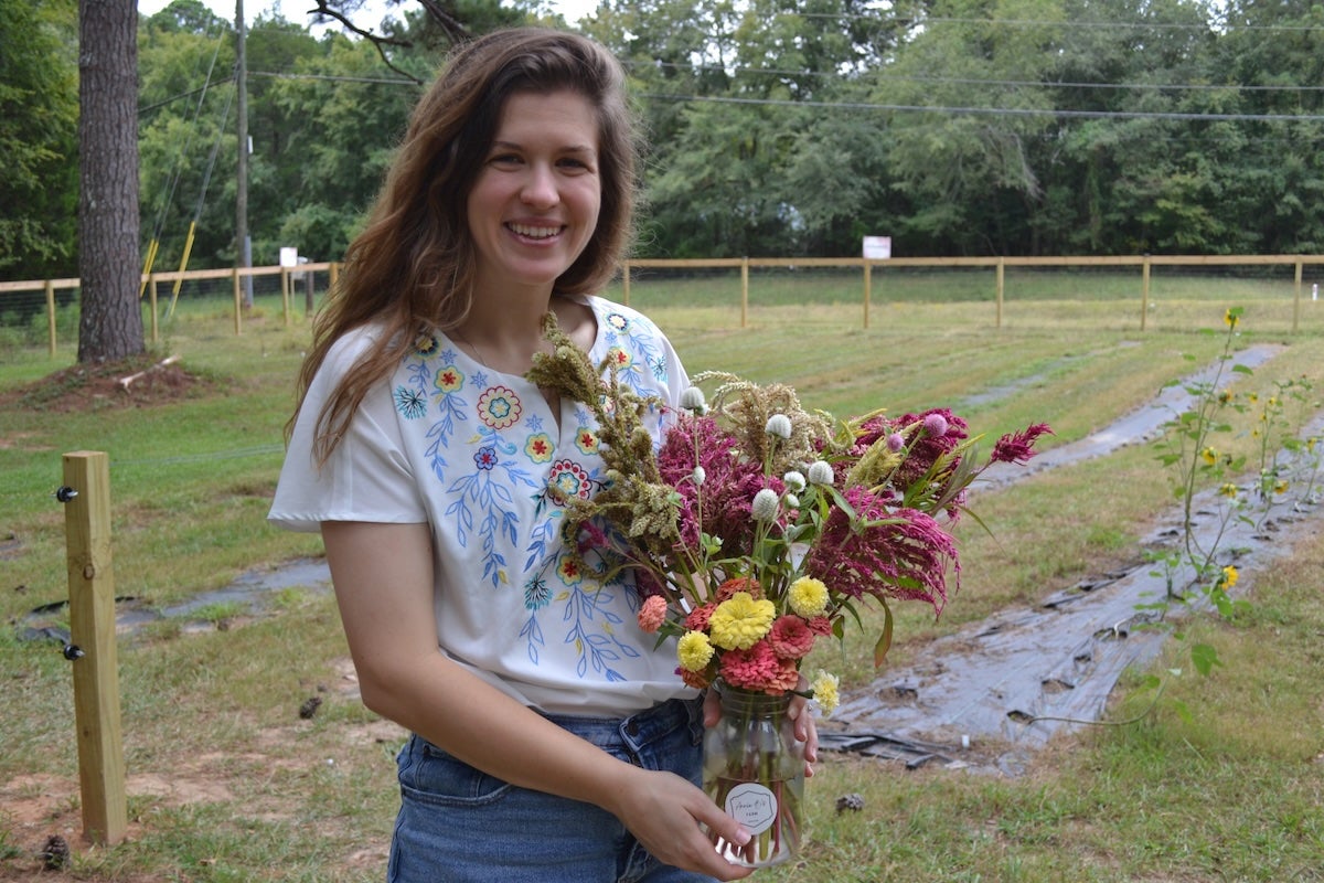 Annie Goble shows off a bouquet of flowers from her flower farm. Staff photo by Stephanie Hill