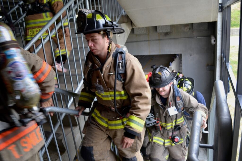 Photo of firefighters climbing stairs