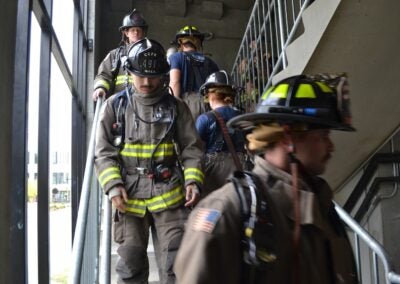 Photo of firefighters climbing stairs