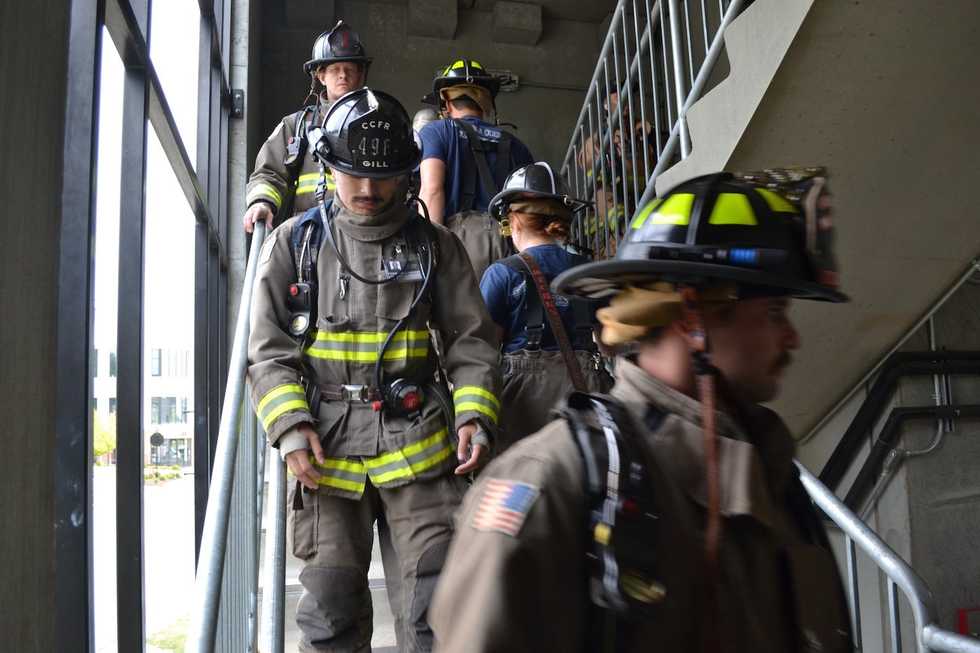 Photo of firefighters climbing stairs