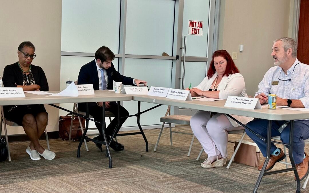 Travis Doss, right, executive director for Richmond County Board of Elections, speaks to board members Monday. From left are Democratic appointee Betty Reece, attorney Sam Mueller and administrative assistant Esther Jackson. Staff photo by Susan McCord