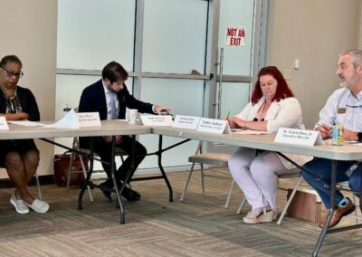 Travis Doss, right, executive director for Richmond County Board of Elections, speaks to board members Monday. From left are Democratic appointee Betty Reece, attorney Sam Mueller and administrative assistant Esther Jackson. Staff photo by Susan McCord