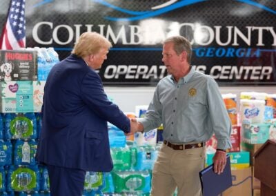 Brian Kemp and Donald Trump shake hands