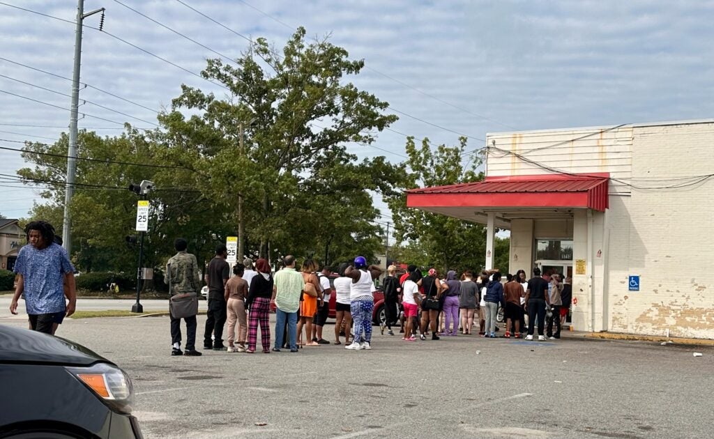 People line up to go inside Family Dollar after Hurricane Helene. Staff photo by Susan McCord