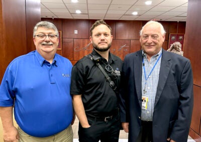 Paramedic Jacob Hansen, center, stands with Central EMS leadership including CEO Gary Coker, right, after being honored for bravery this week before the Augusta Commission. Staff photo by Susan McCord