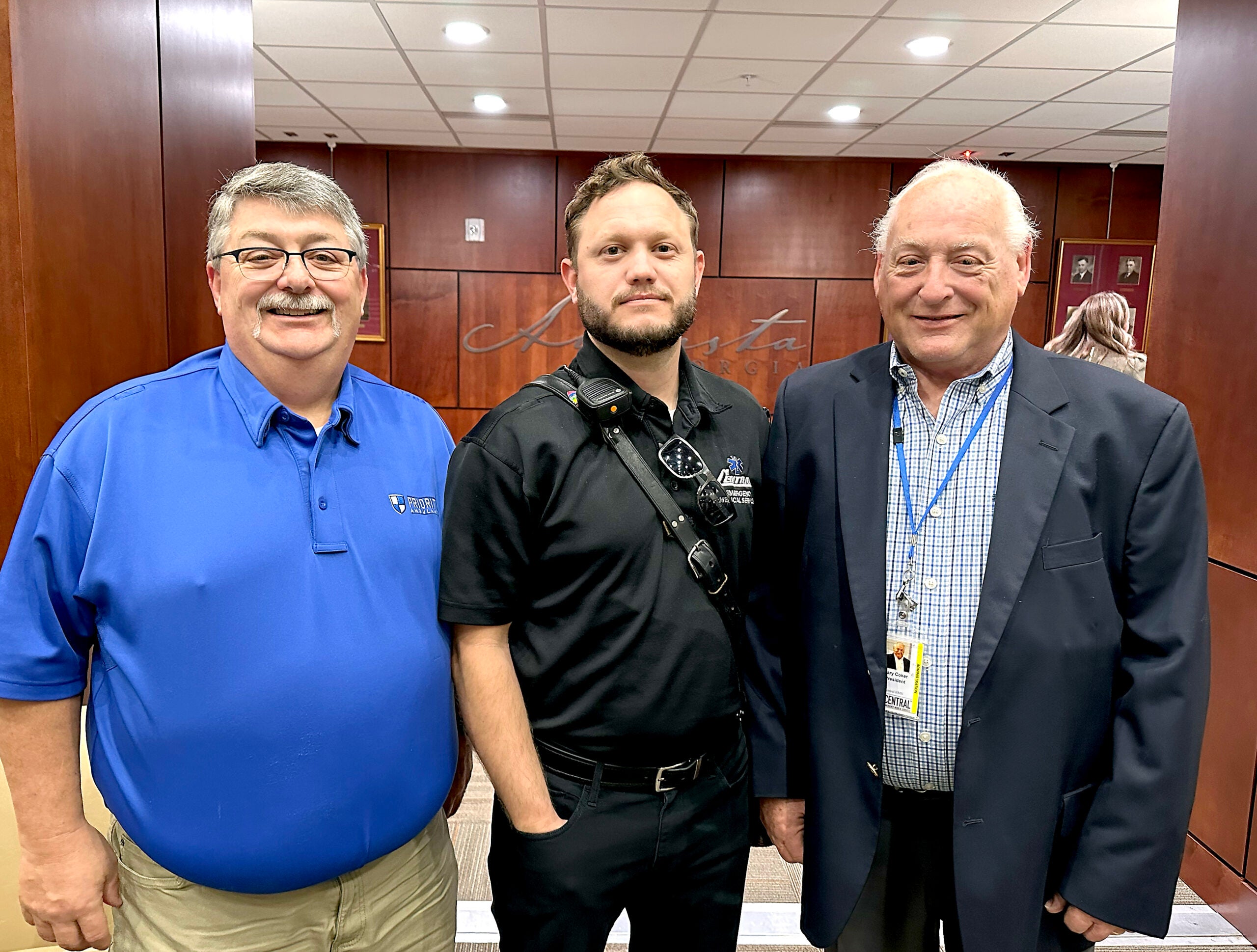 Paramedic Jacob Hansen, center, stands with Central EMS leadership including CEO Gary Coker, right, after being honored for bravery this week before the Augusta Commission. Staff photo by Susan McCord