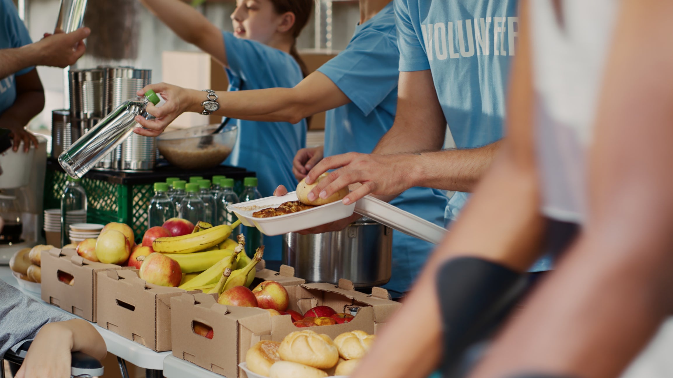 Volunteers prepare supply boxes to hand out to hungry residents. Photo iStockphoto
