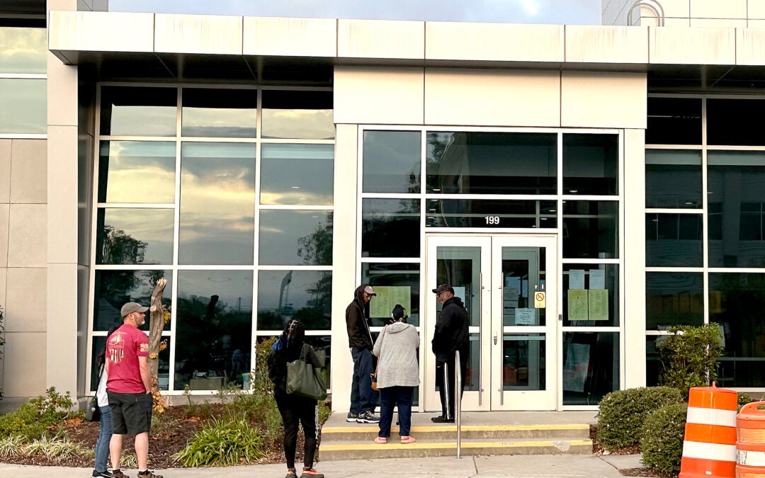 A small line of voters waits for the polling place at Augusta Municipal Building to open Monday. Staff photo by Susan McCord
