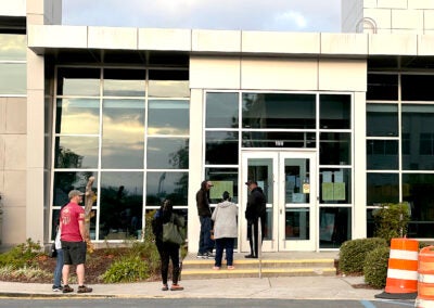 A small line of voters waits for the polling place at Augusta Municipal Building to open Monday. Staff photo by Susan McCord