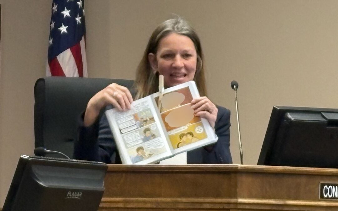 District 1 Commissioner Connie Melear held up a copy of the book "Gender Queer" and showed the images she thought were concerning in the book. The two images depict a sexual act. The Augusta Press has blurred these images to allow for publication. Staff photo by Stephanie Hill