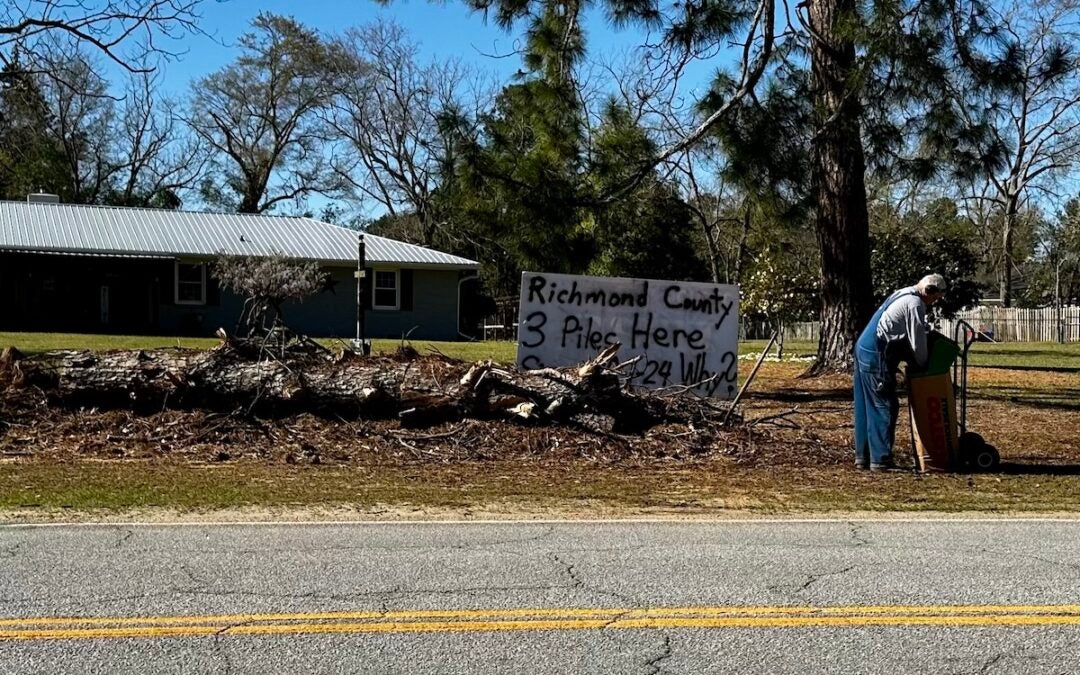 On Skinner Mill Road a resident has a sign asking why the three piles of debris have not been picked up. Staff photo by Susan McCord